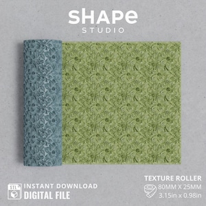 May include: A texture roller with a floral pattern, partially rolled out, displaying a green and blue design. The roller is 3.15 inches wide and 0.98 inches in diameter. The image includes the text "SHAPE STUDIO" and "TEXTURE ROLLER".