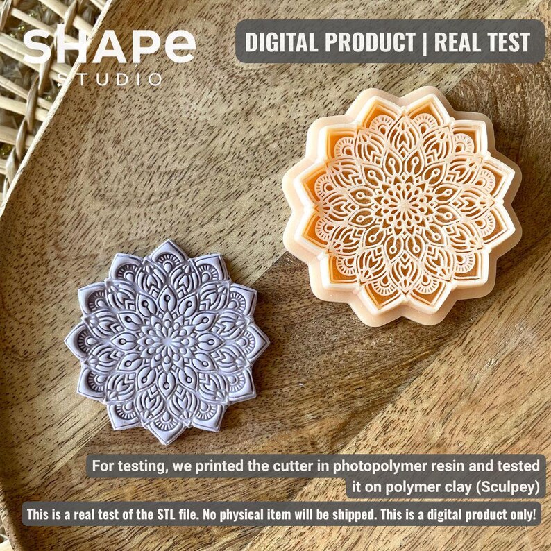 May include: Two mandala-shaped cutters, one gray and one peach-colored, are displayed on a wooden surface. The cutters have intricate floral patterns. The image includes text that reads "DIGITAL PRODUCT | REAL TEST" and "SHAPE STUDIO".