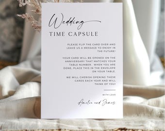 Può includere: Una carta rettangolare bianca per capsula del tempo di matrimonio con testo nero. La carta presenta l'intestazione Wedding TIME CAPSULE, istruzioni per gli ospiti per lasciare un messaggio per il futuro e i nomi Amelia e James in basso.