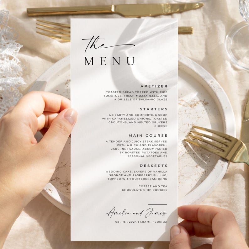 A minimalist wedding menu template held by hands, paired with a classy table setting of golden cutlery and lace, showcasing customizable text for wedding meal details.