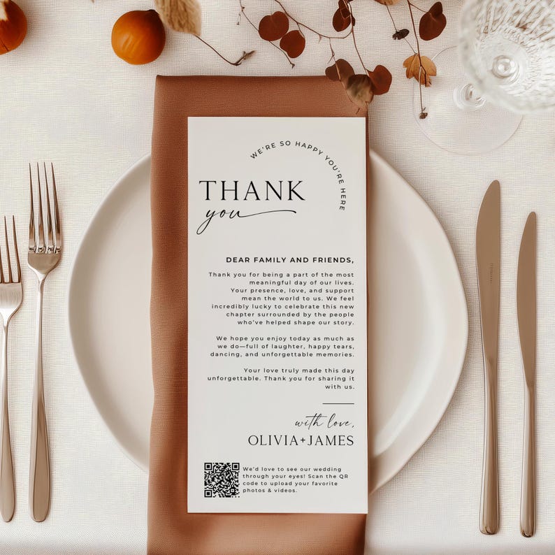 Modern and elegant wedding thank you card placed on a fall-inspired place setting with warm tones and neutral decor. This editable thank you card template includes a heartfelt message and a QR code, making it a unique digital thank you for weddings. A stylish way to gift guests a personalized thank you note they’ll remember. Perfect for use as a printable thank you or place setting card.