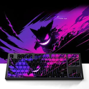 May include: A black mechanical keyboard with a vibrant purple and pink design featuring a cartoon character. The keyboard has black keys and a matching design on the keycaps. The background is black with purple and pink accents.