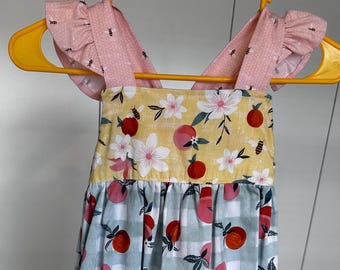Girls Sundress size 3 handmade. This dress features shoulder straps that tie in the back making the length adjustable.