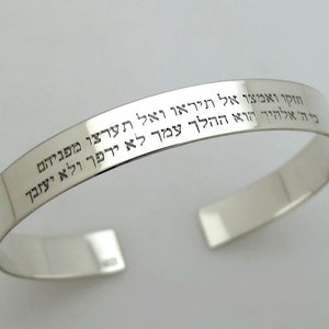 May include: Silver bracelet with Hebrew inscription that reads: "Be strong and courageous, do not be afraid, do not be discouraged, for the Lord your God goes with you; he will never leave you nor forsake you."