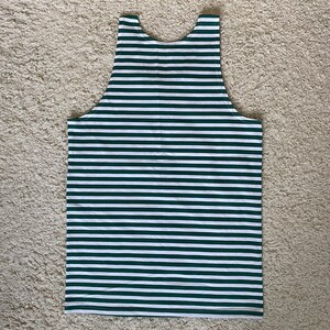 May include: A sleeveless tank top featuring a repeating horizontal striped pattern in dark forest green and crisp white. The garment has a classic scoop neckline and wide shoulder straps, constructed with a clean, straight hemline at the bottom.