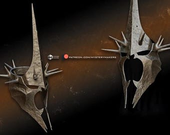 May include: Two silver-colored helmets with sharp points and spikes. The helmets have a dark, almost black, interior. The helmets are similar in design but are slightly different in shape.