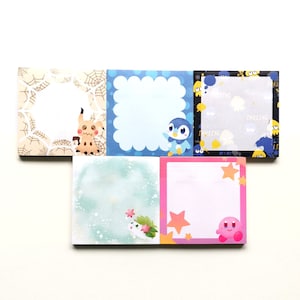 May include: Set of six colourful square sticky notes featuring cartoon characters. The notes are decorated with a variety of designs, including a spider web, a cloud, a star, and a heart.