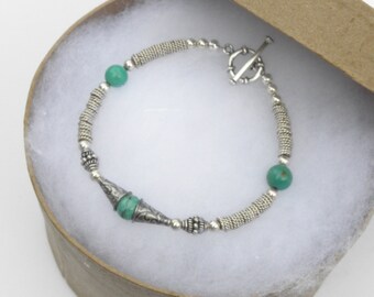 A Smart Casual Handmade Bracelet of Turquoise and Sterling Silver Beads.