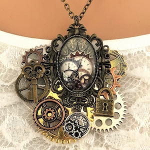 May include: A steampunk-style necklace with a bronze-coloured pendant featuring a clock face, gears, a key, and a lock. The pendant is surrounded by a decorative frame.