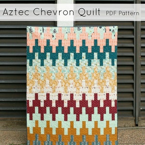 May include: Aztec Chevron Quilt PDF Pattern by Quilts by Emily. A colorful quilt with a chevron pattern in shades of teal, orange, red, and white.