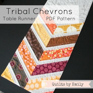 May include: A table runner featuring a chevron pattern in shades of orange, yellow, brown, and burgundy. The fabric is a mix of prints and solids. The text "Tribal Chevrons Table Runner PDF Pattern" is at the top of the image. The text "Quilts by Emily" is at the bottom of the image.