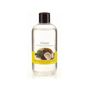 May include: A clear glass bottle with a black lid filled with a clear liquid. The label is yellow with a pineapple and coconut design and the text "Colony", "The Home of Fine Fragrance", "Pineapple Coconut", "Reed Diffuser Refill Oil" and "Aroma Oils de Luxe".