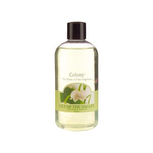 May include: A clear glass bottle with a black cap filled with a yellow liquid. The bottle has a white label with green accents and the text "Colony", "The Home of Fine Fragrance", "Lily of the Valley", "Reed Diffuser Refill Oil", and "Miguel".