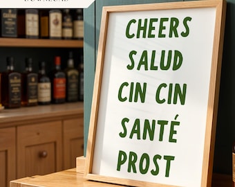 May include: A framed print with the words "Cheers", "Salud", "Cin Cin", "Santé", and "Prost" written in green on a white background.