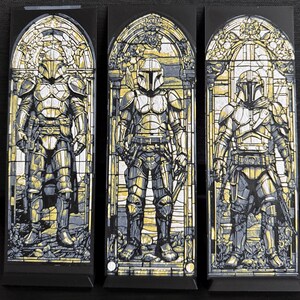 May include: Three panels depicting a figure in armor, reminiscent of stained glass art. The figures are in a standing pose, with a helmet and detailed armor. The color palette includes shades of gray, yellow, and black, creating a striking visual effect.