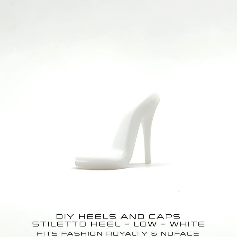 May include: A white stiletto heel, part of a DIY set. The heel is low and slender, with a pointed toe and a high, thin heel. Text at the bottom reads: DIY HEELS AND CAPS, STILETTO HEEL - LOW - WHITE, FITS FASHION ROYALTY & NUFACE.