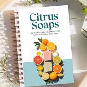May include: A white book with a blue and white cover titled "Citrus Soaps: 50 Beginner-Friendly Recipes for Vibrant Natural Creations". The cover features a colorful arrangement of citrus fruits and soap bars.