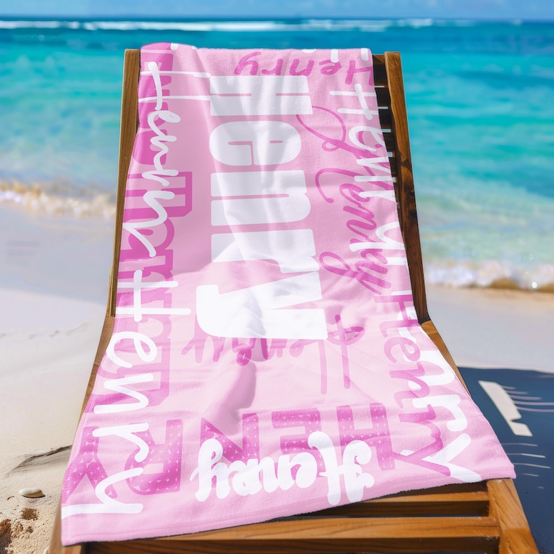 Light pink personalized beach towel with the name Henry in multiple fonts, displayed on a lounge chair by the ocean. Custom name towel, ideal for pool, swim, or summer trips, and a unique gift for all ages.