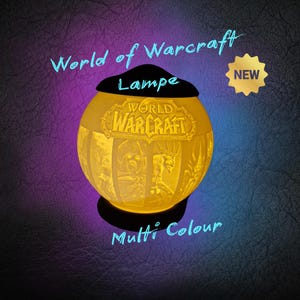 May include: A glowing, spherical lamp with the World of Warcraft logo and character illustrations. The lamp is yellow with a black top and sits on a dark surface. Text on the lamp reads "World of Warcraft Lampe Multi Colour". A gold "NEW" sticker is visible.