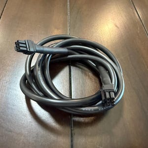 May include: Black electrical cable with two 6-pin connectors. The cable is coiled and the connectors are visible. The cable is labeled "22AWG" and "2464".