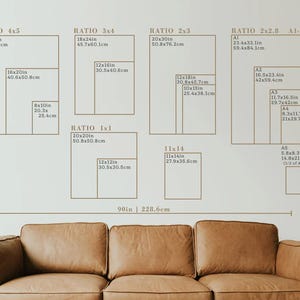 May include: A wall display featuring various print size ratios, including 4x5, 3x4, 2x3, 2x2.8, and 1x1, with measurements in inches and centimeters. A brown leather sofa is in the foreground.