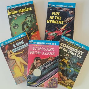 May include: A collection of five vintage science fiction paperback books. The covers feature colorful illustrations and titles like "The Brain-Stealers," "Fire in the Heavens," and "Conquest of the Space Sea." Each book is marked with "ACE TWO COMPLETE NOVELS 35c."