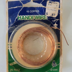 May include: A roll of copper Handi-Wire in its original packaging. The packaging is blue and green with the text "18 Copper Handi-Wire" and "25 FEET". A Kmart price tag is visible.