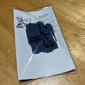 May include: A gray plastic model kit of a 1932 Ford flatbed truck in N scale. The kit is packaged in a clear plastic bag with a white card that reads "Weekend Researches 1932 Ford flatbed truck N scale".