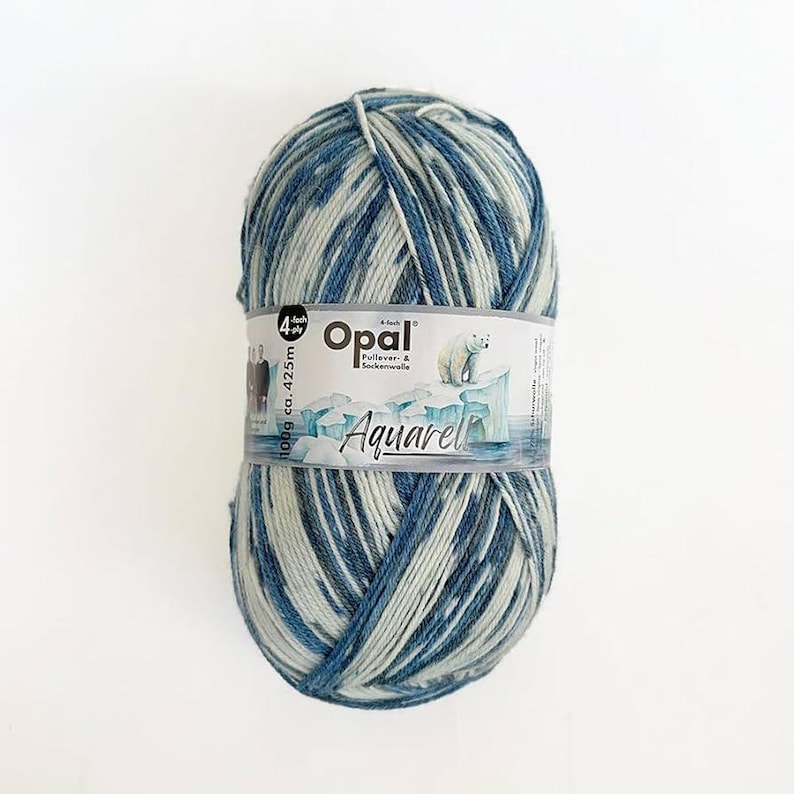 May include: A ball of Opal Aquarel yarn in blue, white, and grey. The yarn is wrapped with a label featuring the brand name, a polar bear graphic, and the text "Aquarel". The ball weighs 100g and has approximately 425m of yarn.
