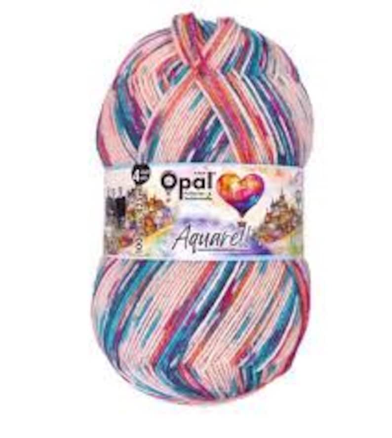 May include: A ball of Opal Aquarell yarn, with a mix of pink, blue, and purple colours. The yarn is wrapped with a label showing the brand name and a heart-shaped design. The yarn is 4-ply.
