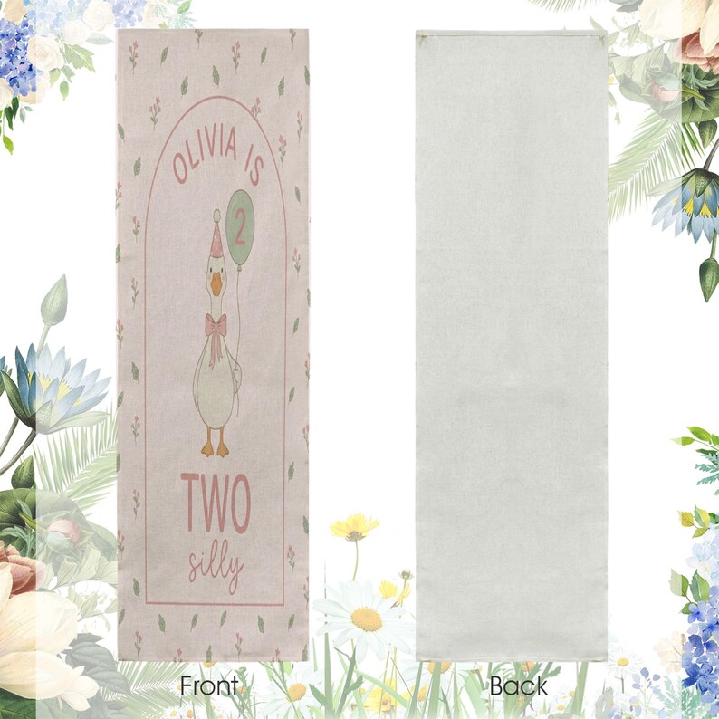 May include: A rectangular, pale pink banner featuring a cartoon goose holding a balloon. The banner has the text "Olivia is 2" and "Two silly" in pink. The reverse side of the banner is plain white.