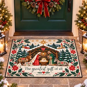 May include: A rectangular doormat featuring a nativity scene with a manger, figures, and animals, surrounded by a festive border of pine branches and poinsettias. The text reads, "The greatest gift of all" and "MATTHEW 1:21" in black script.