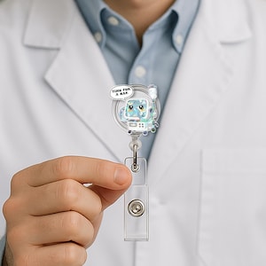 May include: A clear plastic retractable badge holder with a cartoon image of a medical breathing machine with a speech bubble that says "Time for a nap".