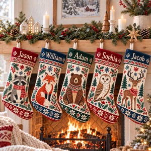 May include: Five Christmas stockings hanging in a row, each featuring a unique woodland animal illustration including a raccoon, fox, bear, owl, and deer. Each stocking is personalized with a name: Jason, William, Adam, Sophia, and Jacob.