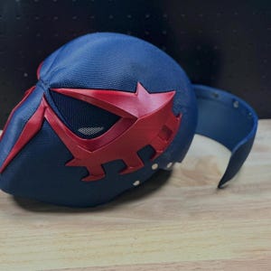 May include: A set of three ceramic mugs with a speckled, cream-colored glaze. Each mug features a different hand-painted floral design in shades of blue, green, and yellow. The mugs have a simple, modern shape.