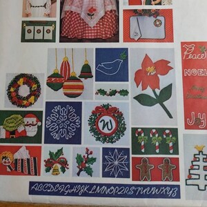 May include: A vintage Vogue Patterns Santa Pack II embroidery pattern booklet with the number 1313 on the cover. The cover features a variety of Christmas-themed embroidery designs, including wreaths, ornaments, snowflakes, candy canes, and a gingerbread man. The alphabet is printed at the bottom of the page.