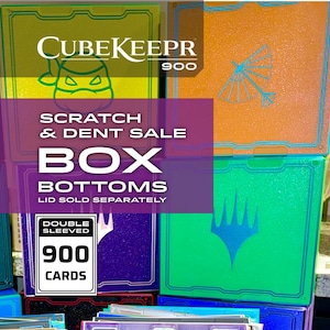 May include: A collection of CubeKeepr 900 card storage boxes in various colors including lime green, orange, purple, and bright green. Each box features a unique graphic icon, a textured finish, and text indicating a scratch and dent sale for box bottoms.