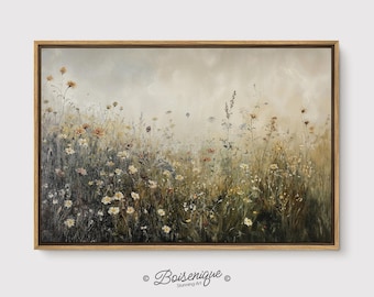 May include: A framed canvas print of a field of wildflowers in muted tones. The artwork features a variety of flowers in shades of white, yellow, and brown, set against a soft, hazy background. The frame is a light brown color, and the artwork is signed "Boisenique".