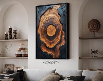 May include: A framed wooden art piece featuring a cross-section of a tree trunk, showcasing concentric rings in shades of brown and gold. The artwork is set against a dark background and framed in black. The piece is signed "Boisenique".