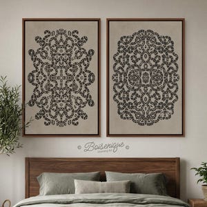 May include: Two framed wall art pieces with dark brown intricate patterns on a beige background. The artwork is displayed above a bed with green pillows and a wooden headboard. The brand name "Boisenique" is visible.