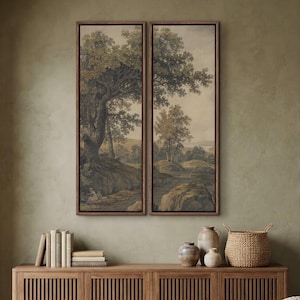 May include: Two vertical framed wall art prints featuring a continuous landscape scene with large green trees, rocky terrain, and a muted earth-toned sky. The artwork is displayed in dark wood frames, showcasing a detailed forest environment.