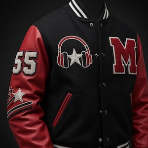 May include: A black varsity jacket with red sleeves, featuring a white and red headphone and star patch on the chest, a large red letter M, and the number 55 with star accents on the sleeve. The jacket has a snap button closure and striped trim.