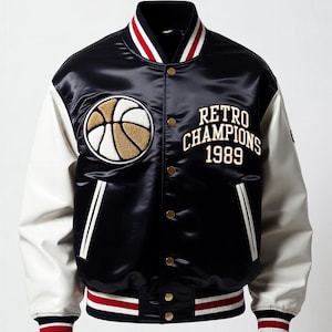 May include: Black satin varsity jacket with white sleeves. Features a basketball emblem and the text "RETRO CHAMPIONS 1989" in gold lettering. The jacket has a striped collar, cuffs, and hem in red, white, and black.