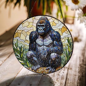 May include: A stained glass window hanging on a chain, depicting a gorilla sitting in a jungle setting. The gorilla is made of blue, black, and white glass pieces. The background is a mix of yellow, green, and blue glass.