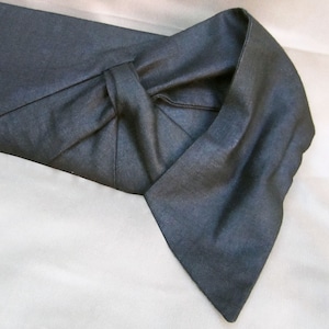 May include: A dark blue fabric collar with a folded edge. The fabric is smooth and has a slight sheen.