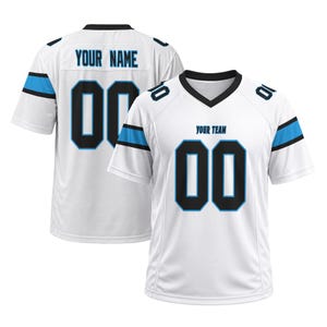 May include: A white athletic jersey with black and blue accents, featuring a V-neck collar, short sleeves, and the text YOUR TEAM on the front. The back displays the text YOUR NAME above the number 00, with matching black and blue stripes.