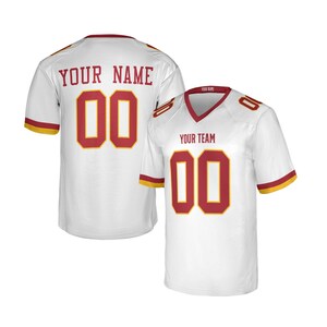 May include: A white short-sleeved sports jersey with a V-neck collar. The front features the text YOUR TEAM above the number 00 in red with yellow outlines. The back displays YOUR NAME above the number 00 in red with yellow outlines.