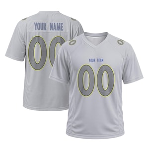 May include: A light gray short-sleeved sports jersey with a V-neck collar. The front displays the text YOUR TEAM above the number 00 in gray with a yellow outline. The back features the text YOUR NAME above the number 00 in the same color scheme.