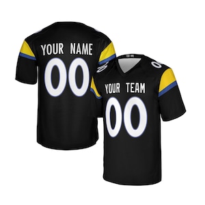 May include: Black football jersey with white numbers and lettering. The jersey has a V-neck and features the text "YOUR TEAM" and "YOUR NAME" along with the number "00". Yellow and blue accents are on the sleeves.