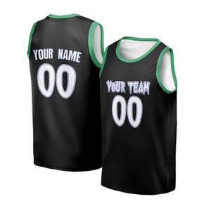 May include: Two black basketball jerseys with white and green trim. One jersey has "YOUR NAME" and the number "00". The other jersey displays "YOUR TEAM" and the number "00". Both jerseys have a white interior.